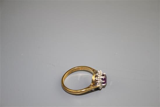 A modern 18ct gold, amethyst and diamond set circular cluster ring, size I, gross weight 3.2 grams.